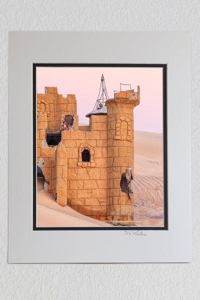 8 x 10 luster print in a 11 x 14 ivory and black double mat of This is what remains of a putt putt golf course at Jockey's Ridge State Park. Over the years blowing sand has completely covered this castle. It has been slowly uncovered over the past 10 years and reburied.