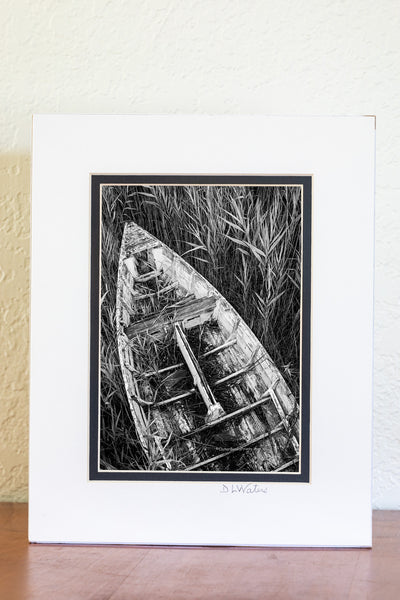 An abandon skiff in the reeds along the Manteo waterfront on the Outer Banks in NC. I set the self timer on my camera and held my tripod high above my head to capture this photograph. I felt this one look best in black-and-white.