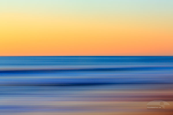 A Outer Banks beach sunrise reduced to colors and lines. Using camera movement during a long exposure to blur the beach and ocean.