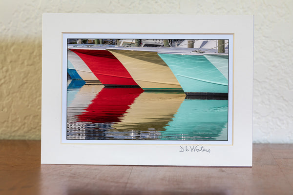 A line of fishing boats and reflections at Hatteras Harbor Marina.