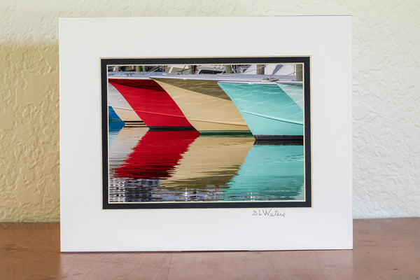A line of fishing boats and reflections at Hatteras Harbor Marina.