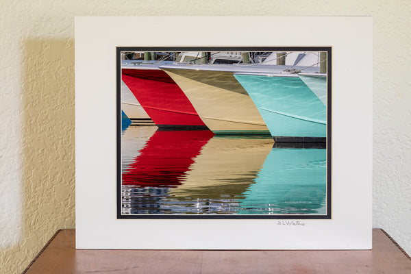 A line of fishing boats and reflections at Hatteras Harbor Marina.