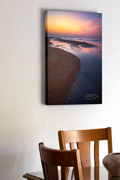 Empty beach with tide pools at sunrise on Frisco Beach. Cape Hatteras Outer Banks of North Carolina.