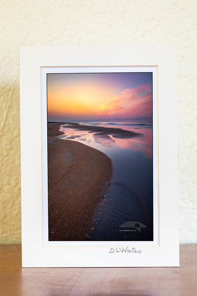 Empty beach with tide pools at sunrise on Frisco Beach. Cape Hatteras Outer Banks of North Carolina.
