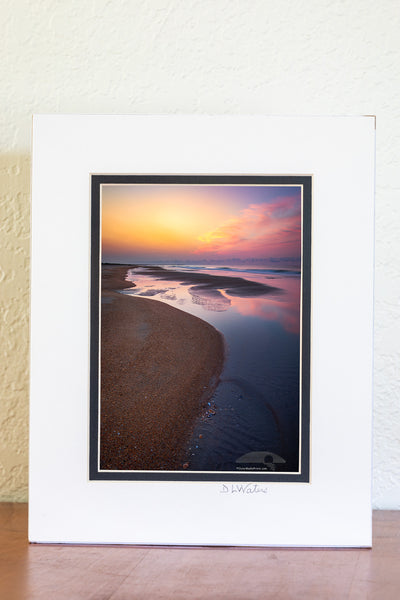 Empty beach with tide pools at sunrise on Frisco Beach. Cape Hatteras Outer Banks of North Carolina.
