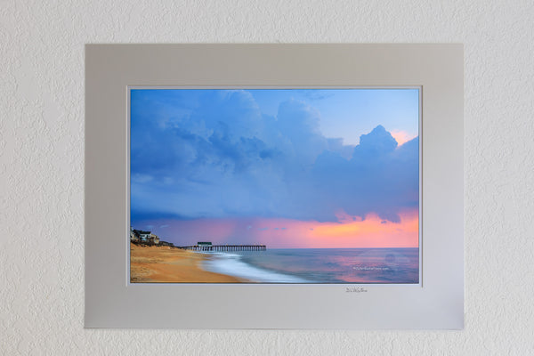 Storm clouds before sunrise above Kitty Hawk Pier on the Outer Banks of North Carolina.