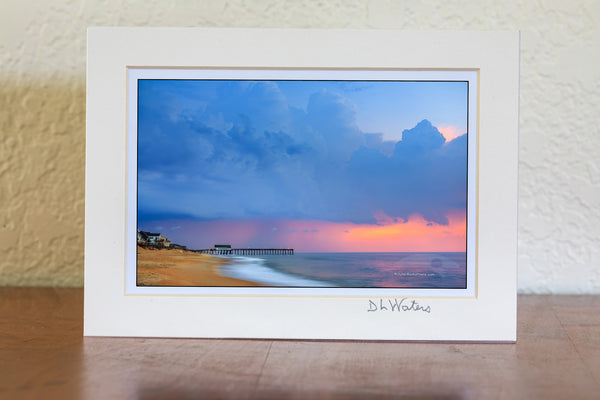 Storm clouds before sunrise above Kitty Hawk Pier on the Outer Banks of North Carolina.
