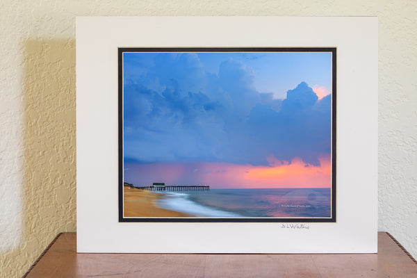 Storm clouds before sunrise above Kitty Hawk Pier on the Outer Banks of North Carolina.