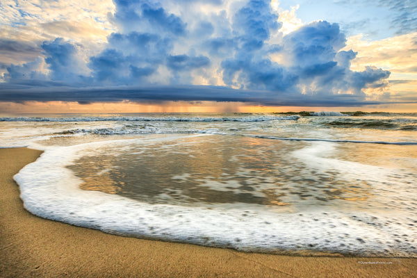 Surf foam rolling in and a rain storm out to sea on the Outer Banks of NC.