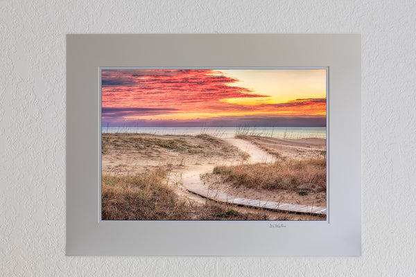 13 x 19 luster print in 18 x 24 ivory mat of Clouds at sunris with a curvy path leading to a Kitty Hawk Beach on the Outer Banks of NC.