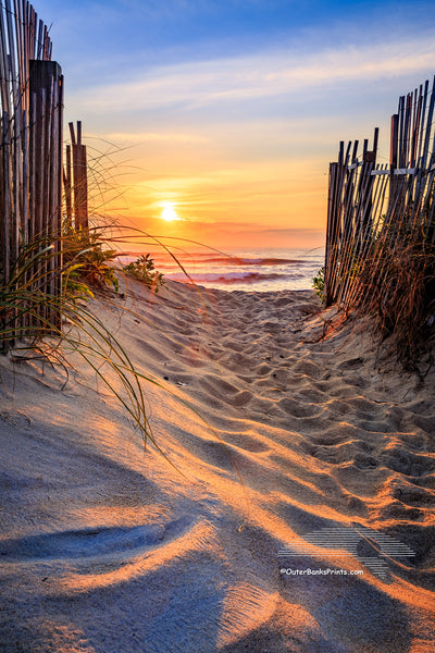Kitty Hawk beach access at sunrise on the Outer Banks, NC. It's interesting how the sunlight plays across the foot prints in the sand.