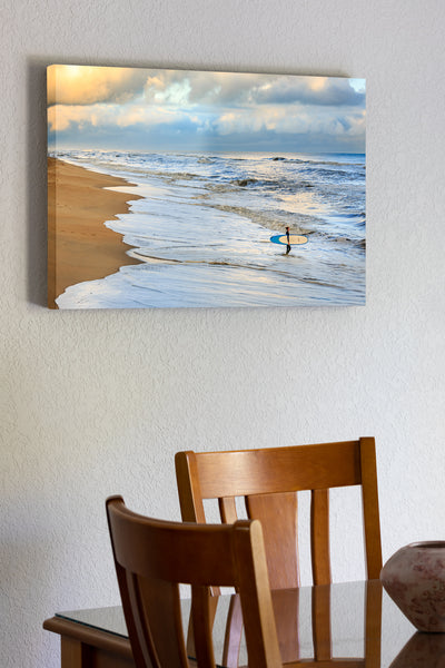 20"x30" x1.5" stretched canvas print hanging in the dining room of Picture of Nags Head beach. an early-morning surfer wadding into the ocean.