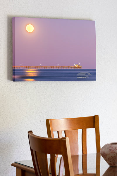 Hunters moon rising over Cherry Grove pier in North Myrtle Beach, South Carolina