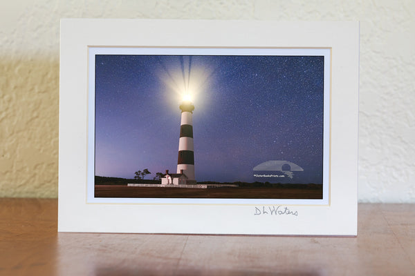 Beneath a sky scattered with stars, the Bodie Island Lighthouse casts its light across Cape Hatteras National Seashore on the Outer Banks of North Carolina.

Fun Facts About Bodie Island Lighthouse
Light Visibility
The lighthouse’s powerful first-order Fresnel lens projects its beam up to 19 nautical miles (about 22 miles) out to sea on a clear night—making it a vital navigational aid along the “Graveyard of the Atlantic.

Flash Pattern
Its light has a distinctive flashing sequence: 2.5 seconds on, 2.5 seco