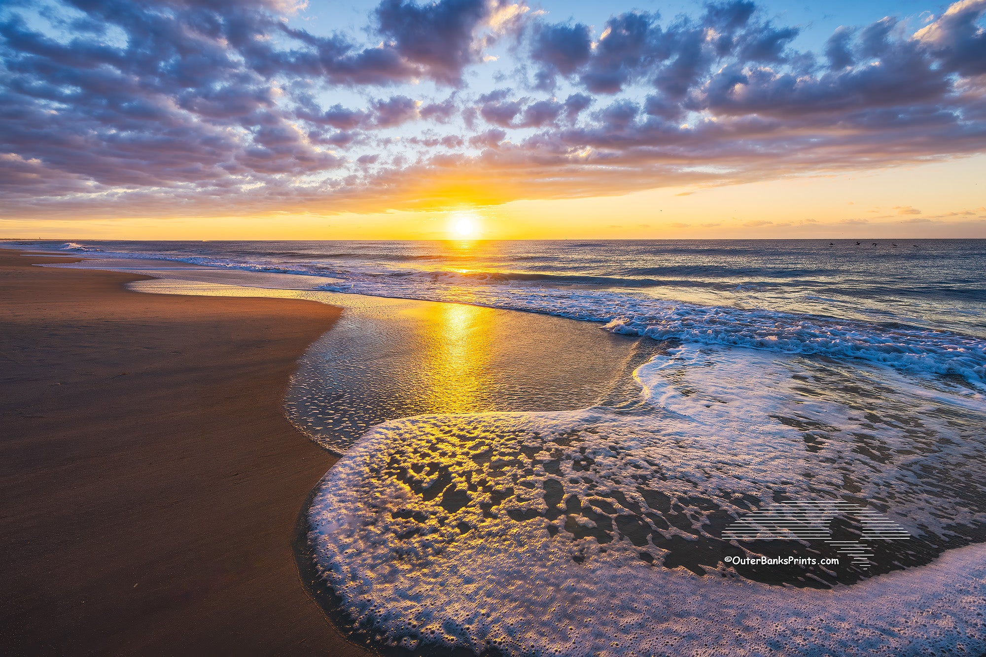 While camping on Cape Hatteras National Seashore at Frisco Campground we got up to see this magical sunrise over the ocean.