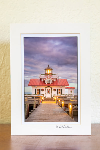 Roanoke Marshes Lighthouse decorated for Christmas at sunset on the waterfront at Manteo Outer Banks North Carolina.