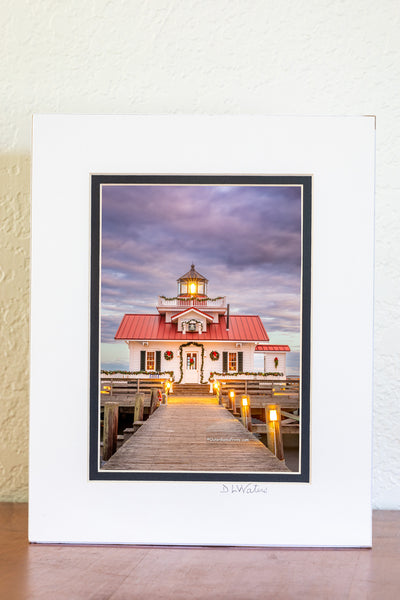 Roanoke Marshes Lighthouse decorated for Christmas at sunset on the waterfront at Manteo Outer Banks North Carolina.