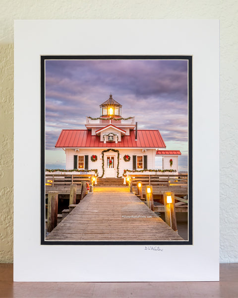 Roanoke Marshes Lighthouse decorated for Christmas at sunset on the waterfront at Manteo Outer Banks North Carolina.