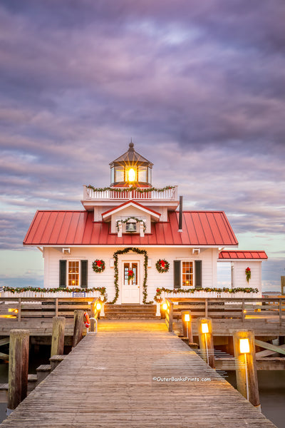 Roanoke Marshes Lighthouse decorated for Christmas at sunset on the waterfront at Manteo Outer Banks North Carolina.