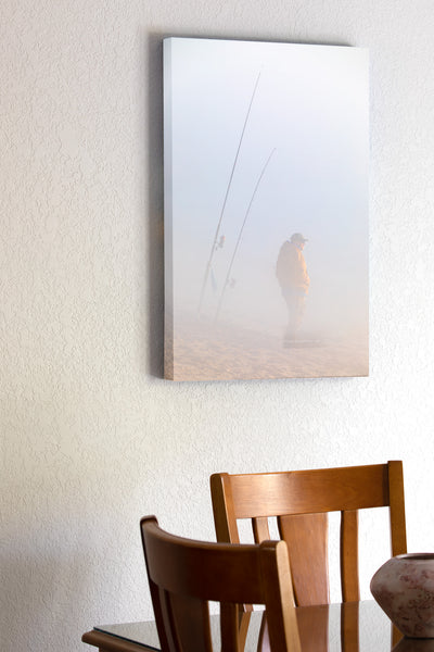 Fisherman hoping to catch some fish on this foggy winter morning at Cape Hatteras National Seashore  at the beach in Buxton North Carolina.