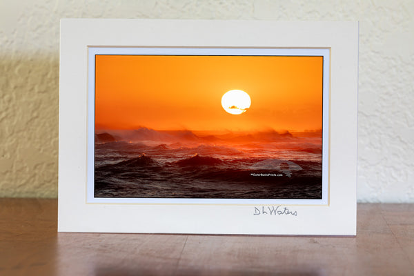 Sunset from Cape Point on Cape Hatteras Island looking towards Hatteras Village across a firey windsweept sea.