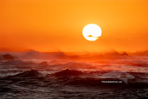 Sunset from Cape Point on Cape Hatteras Island looking towards Hatteras Village across a firey windsweept sea.