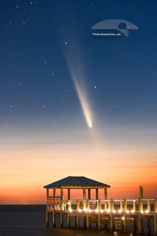 The comet known as C/2023 A3 Tsuchinshan-ATLAS, shines over Kitty Hawk Bay at twilight, captured from Kill Devil Hills beach boat ramp. The gazebo and dock in the foreground add a peaceful touch to this Outer Banks view.