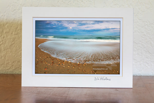 A slow shutter speed reveals the contrast between the recently deposited sharp shell shards and the receding wave at Frisco, North Carolina in Cape Hatteras National Seashore on the Outer Banks.