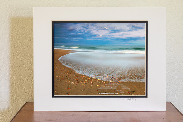 A slow shutter speed reveals the contrast between the recently deposited sharp shell shards and the receding wave at Frisco, North Carolina in Cape Hatteras National Seashore on the Outer Banks.