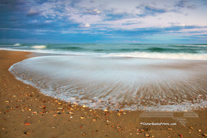 A slow shutter speed reveals the contrast between the recently deposited sharp shell shards and the receding wave at Frisco, North Carolina in Cape Hatteras National Seashore on the Outer Banks.