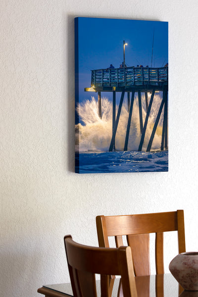 Just before Dawn large waves crash into Avalon fishing pier on the Outer Banks of North Carolina.