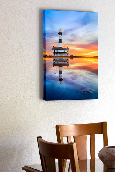 20"x30" x1.5" stretched canvas print hanging in the dining room of Reflection of sunrise and Bodie Island Lighthouse after a hard rain.