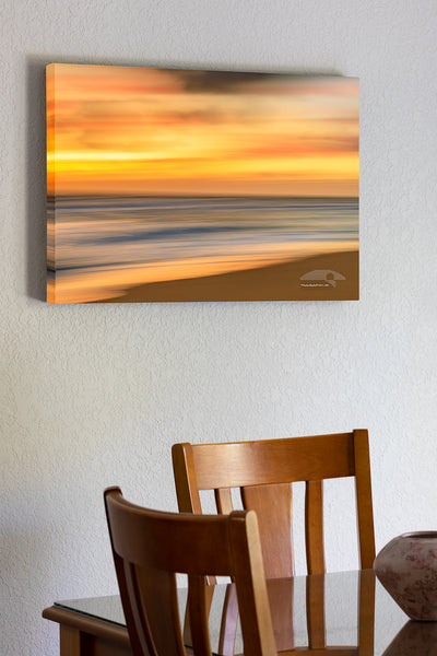 20"x30" x1.5" stretched canvas print hanging in the dining room of Soft gold sunrise Beach photo was created by using a long shutter speed and moving the camera a Kill Devil Hills beach on the outer banks of NC.