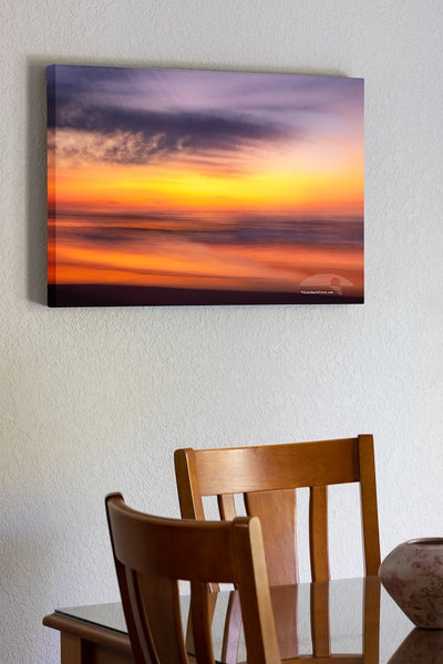 20"x30" x1.5" stretched canvas print hanging in the dining room of This sunrise beach impression was captured bouncing along wile driving on the beach using a 1/4 second shutter speed. in Corolla on the Outer Banks of North Carolina.