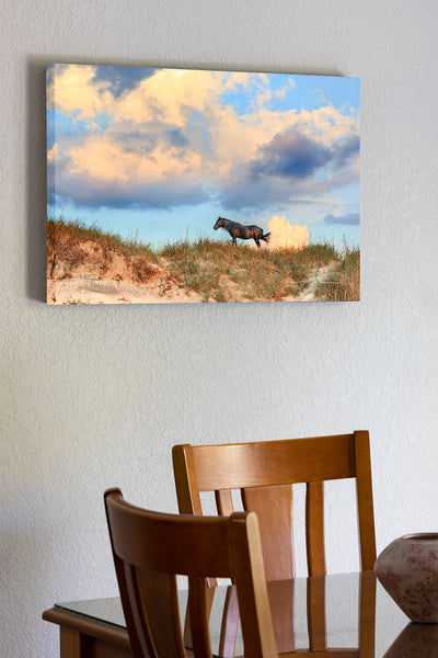 20"x30" x1.5" stretched canvas print hanging in the dining room of Stallion, dunes, and clouds at sunrise in Corolla on the Outer Banks of North Carolina.