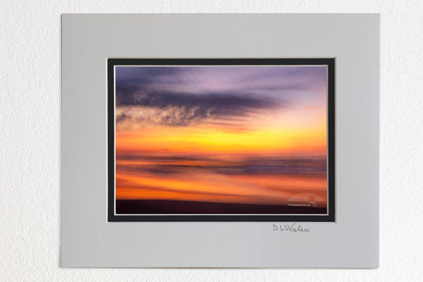  5 x 7 luster prints in a 8 x 10 ivory and black double mat of This sunrise beach impression was captured bouncing along wile driving on the beach using a 1/4 second shutter speed. in Corolla on the Outer Banks of North Carolina.