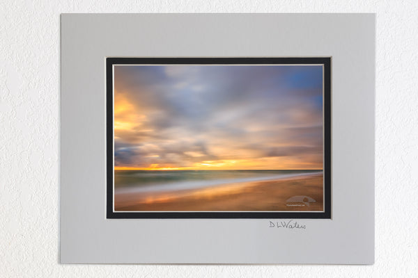 5 x 7 luster prints in a 8 x 10 ivory and black double mat of A one minute exposure of sunrise on a Kitty Hawk Beach on the Outer Banks, NC.
