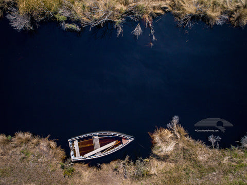 Aerial photo of a wooden skiff on a creek off the Albemarle Sound in Alligator River Wildlife Refuge.
