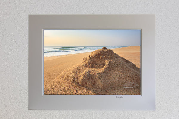 13 x 19 luster print in 18 x 24 ivory ￼￼mat of Sunrise sand castle after a rain storm at a Outer Banks beach.