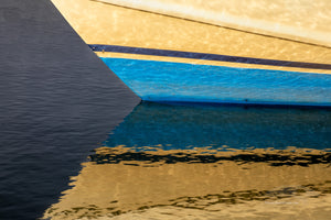 Fishing boat bow and reflection at Hatteras Harbor Marina, NC.