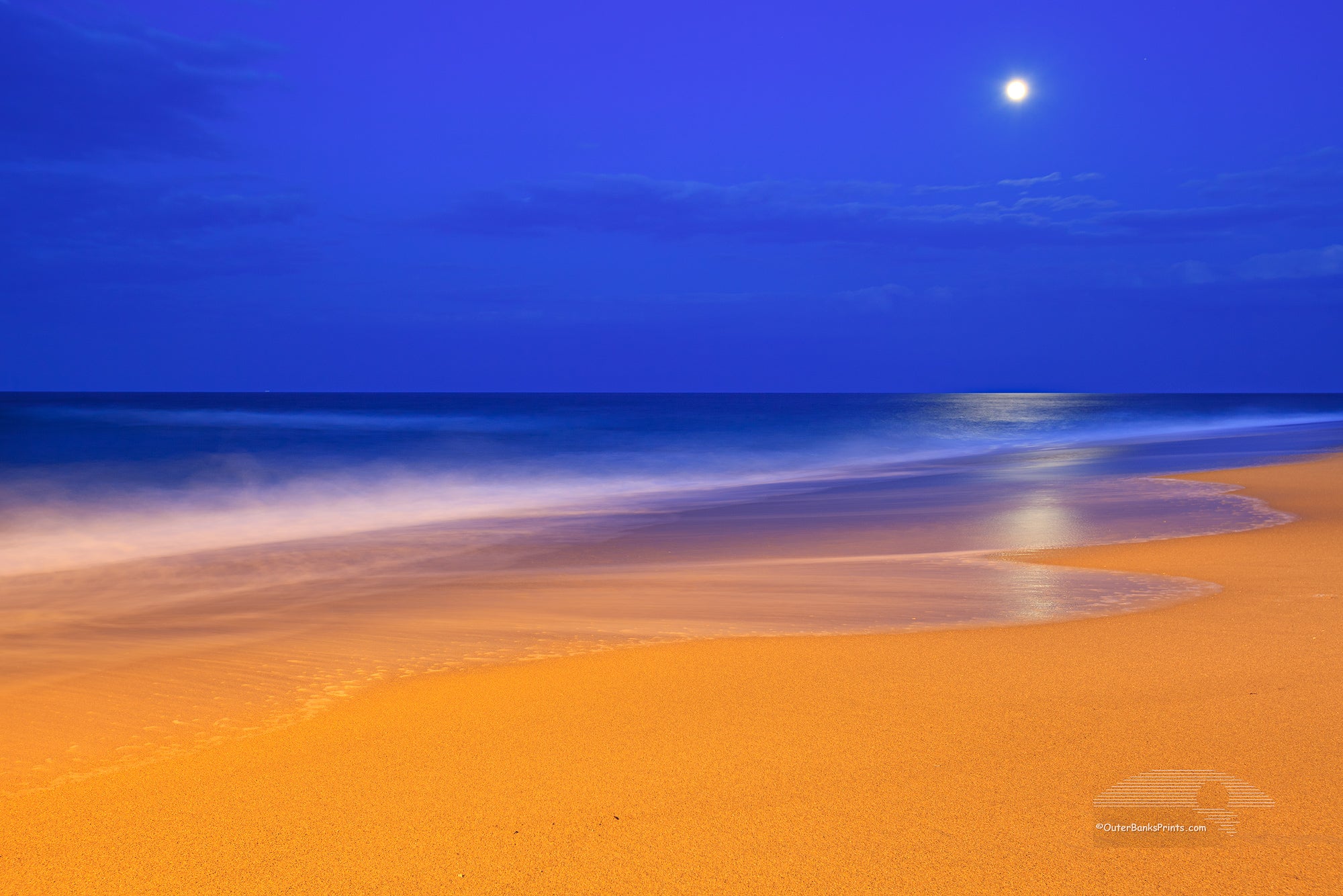 These colors are pretty much how I saw  them.  The yellow on the beach is from an incandescent spotlight shining from Kitty Hawk pier. The blue in the sky is the natural twilight color. I had to use a long exposure to gather enough light. The waves became very soft as they moved during the exposure.