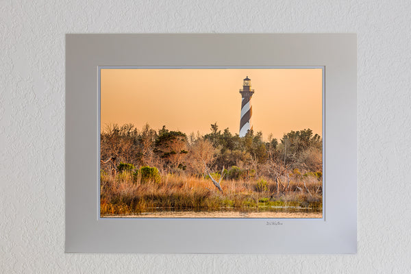 13 x 19 luster print in 18 x 24 ivory ￼￼mat of Cape Hatteras Lighthouse and reflection on Hatteras Island. This iconic spiral lighthouse is still in use today.