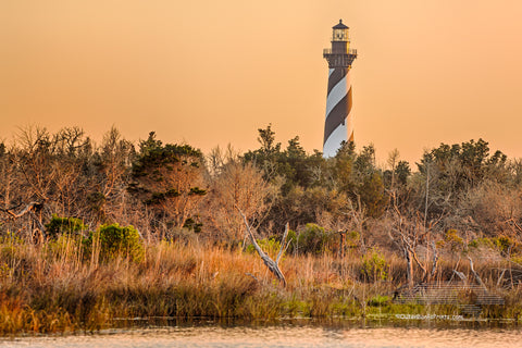 Cape Hatteras Lighthouse and reflection on Hatteras Island. This iconic spiral  lighthouse is still in use today.
