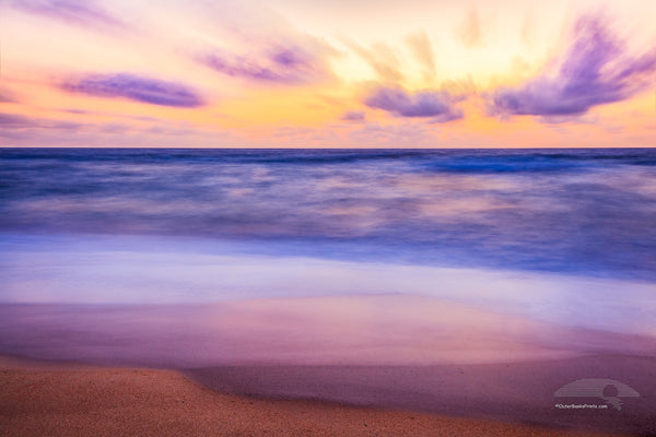 Colorful long exposure of clouds and surf at Kitty Hawk beach on the Outer Banks of North Carolina.