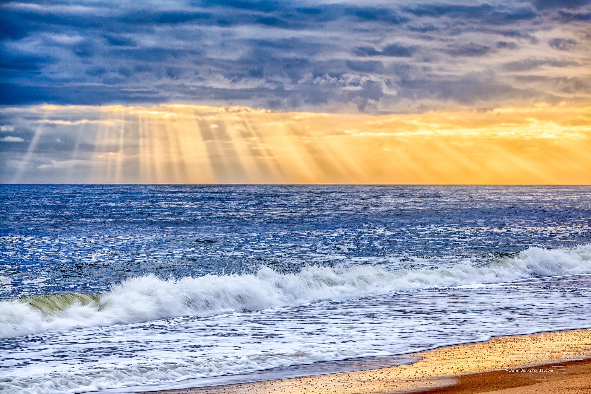 Sun rays breaking through a stormy sky over the beach on the Outer Banks.