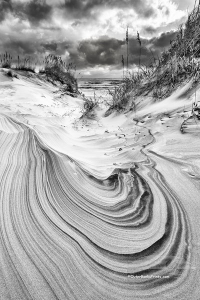 Black and white sand dune and sky in Corolla on the Outer Banks of North Carolina.