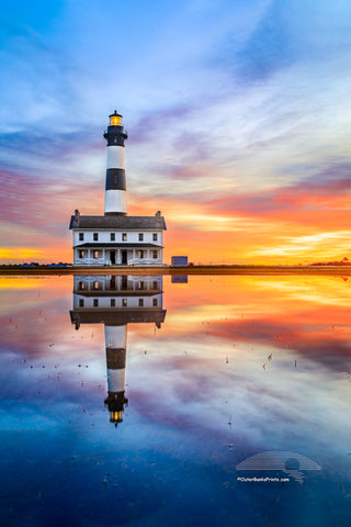 Reflection of sunrise and Bodie Island Lighthouse after a hard rain.