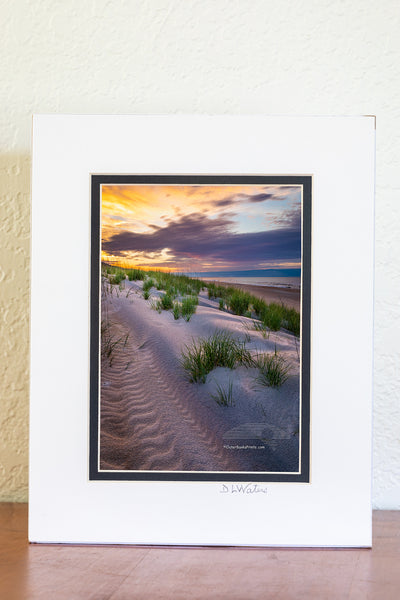 5 x 7 luster  print in a 8 x 10 ivory and black double mat of  Break of Day Sunrise over the dunes at Frisco beach Cape Hatteras National Seashore on the Outer Banks of North Carolina. Because of the way Cape Point is positioned, Frisco Beach is the only place that I know of on Outer Banks that the sun rises along the beach.