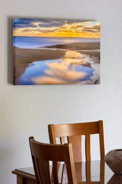 20"x30" x1.5" stretched canvas print hanging in the dining room of A tide pool at Kitty Hawk beach on the Outer Banks of NC reflecting a tranquil sunrise.