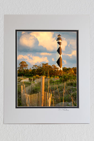 8 x 10 luster print in a 11 x 14 ivory and black double mat of Sand fence and clouds at Cape Lookout Lighthouse on the Outer Banks of NC.